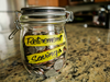 Retirement_Savings_Money_Jar._A_clear_glass_jar_filed_with_coin