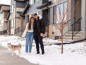 Mike Gjura and Michelle Yee and their Pomsky, Cato, at their townhome by Alliston in Wolf Willow.