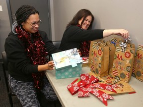 Lesley Plumley, right, and assistant Shanae Sibbald from LP Events prepare gift bags and table settings for upcoming seasonal parties near Calgary on Monday, December 5, 2022.