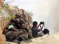 In this file photo taken on May 15, 2007, African Union peacekeepers take cover as two Somali photographers point their cameras towards the site where the troops were detonating seized ammunition in Mogadishu.