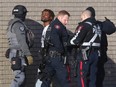 Calgary police take a man into custody after a disturbance at a CIBC bank on 17th Avenue S.W. onFriday, Dec. 9, 2022.