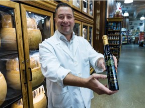 Store manager Gino Marghella holds a bottle of Canadian produced olive oil from Saltspring Island at the Italian Centre in Calgary on Thursday, November 24, 2022.  
Gavin Young/Postmedia
