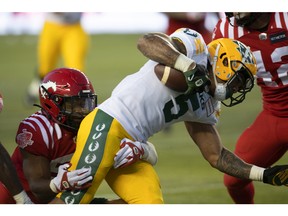 Calgary Stampeders DB Brad Muhammad will work on Edmonton Elks' ball carrier Jalin Marshall during the second half of the CFL pre-season action at Edmonton in this photo from June 3rd.