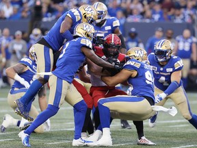 The Bombers gang tackle running back Ka-Deem Carey.