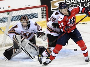 The Hurricanes have a shot at Hitmen goaltender Ethan Buenaventura during the second period of action as the Calgary Hitmen host the Lethbridge Hurricanes at the Saddledome for their final game of the season. April 17, 2022. Brendan Miller/Postmedia