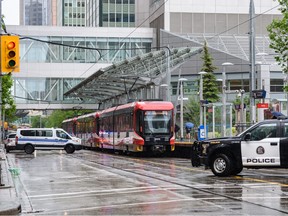 Calgary Police and Transit Peace Officers investigate an incident at the 8 Street CTrain station in downtown Calgary, Tuesday, June 14, 2022.