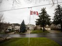 The Canadian flag hovers in front of homes near Toronto. The Bank of Canada's latest rate hike will make homeowners feel even more pain.
