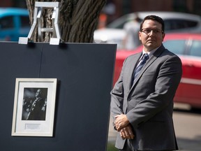 Jesse Hopkins, the son of the late John Hopkins, stands by the plaque during a formal event when the Saskatchewan government and the family of the late John Hopkins unveiled a new sign showing the new name of the John Hopkins Regina Soundstage. is standing on