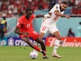 Canada's Ismaël Koné battles Morocco's Sofiane Boufal during World Cup Group F match in Doha, Qatar, On Dec. 1, 2022.