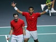 Canadas Felix Auger-Aliassime, right, and Vasek Pospisil celebrate after winning the men's double semi-final tennis of the Davis Cup tennis tournament match between Italy and Canada at the Martin Carpena sportshall, in Malaga on November 26, 2022.