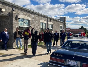 The AKOOLFILM Company production crew prepares to film a scene involving actors Felipe Aukai (Frank Klassen) and Jim Monaco (Detective Forbes) and a group of extras at the St. Marys municipal operations centre Friday morning. (Photo by Sheri LeBlanc)