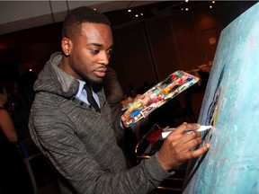 Artist Allan Andre works on his live art installation at Vivante gala, held Saturday, February 9, 2013, at the Ottawa Police Association banquet hall. (Photo by Caroline Phillips)