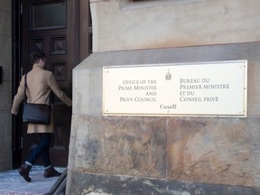 Employees arrive at the Prime Minister's Office in Ottawa on Monday, February 17, 2020.
