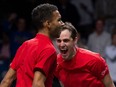 Canadas Felix Auger-Aliassime (left) and Vasek Pospisil celebrate after winning the men's double semi-final tennis of the Davis Cup tennis tournament match between Italy and Canada at the Martin Carpena sportshall, in Malaga on Nov. 26, 2022.