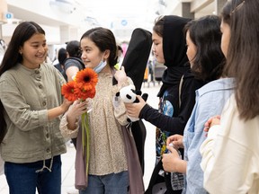 Nila Ebrahimi, second from left, was greeted by her classmates from Malephat High School at Saskatoon International Airport on August 27, 2022.