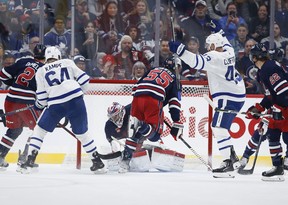 Maple Leafs’ Kyle Clifford (43) celebrates David Kampf’s (64) goal against Winnipeg Jets goaltender Connor Hellebuyck (37) during second period NHL action in Winnipeg, Saturday, October 22, 2022. THE CANADIAN PRESS/John Woods