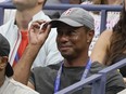 Tiger Woods tips his hat to the crowd during a match between Serena Williams and Anett Kontaveit, of Estonia, in the second round of the U.S. Open tennis championships, Wednesday, Aug. 31, 2022, in New York.