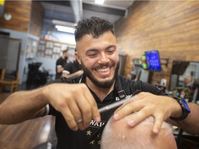 Silver Elia, owner of The Mane Station in Tecumseh, cuts a client’s hair on Friday, August 19, 2022.