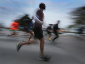 Detroit Free Press marathon runners are shown along Riverside Drive West in downtown Windsor on Sunday, October 16, 2022.