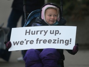 Kinley Butler holds a sign during the Detroit Free Press marathon in downtown Windsor on Sunday, October 16, 2022.
