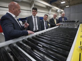 James Richards, left plant manager of MC3 Manufacturing, MPP Andrew Dowie, MPP Anthony Leardi, Victor Fedeli, Ontario Minister of Economic Development, Job Creation and Trade and Abe Klassen, CEO/President of MC3 Manufacturing speak at a press conference on Wednesday, October 19, 2022 at MC3 Manufacturing in Kingsville.