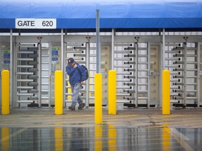 A worker exits the Ford Annex Engine Plant after the day shift, on Monday, Oct. 17, 2022.