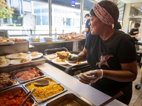 Claire Dickenson helps prepare Thanksgiving turkey dinners for guests at Windsor’s Downtown Mission on Tuesday.