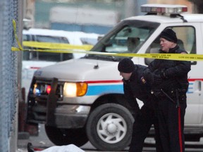 Calgary police at the scene of the shooting death of FK gang member Mark Kim on Dec. 31, 2007. A decrease in violence between warring Calgary gangs is likely partially responsible for a downward trend in homicides in the city. There have been three so far in 2011.