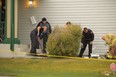 Firefighters and police officers clean up in the aftermath of a fatal shooting at a home on Citadel Peak Circle N.W. Officers shot Peter Spiewak, 32, when he came to the door with an axe. He died at the scene.