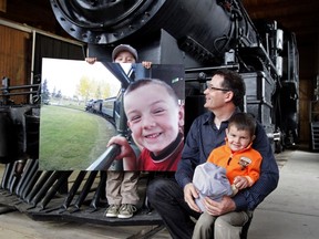 Joe Fraser holds the picture his grandfather, Grant Fraser, took of him at Heritage Park that won the Capture WOW contest by Tourism Calgary. Grant Fraser holds his other grandson Gabriel Fraser at Heritage Park.