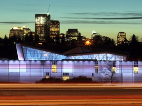 Cars streak by on the Deerfoot Trail passing Telus Spark, Calgary's new science centre, as the skyline looms in the background.