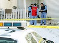 Investigators examine a home in the 3600 block of 39th Street N.E. Officers responding to a 911 call Friday found a woman dead inside. The woman's common-law spouse has been charged with second-degree murder.
