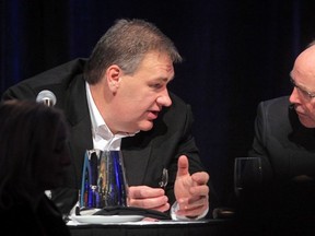 CNRL vice-chairman Murray Edwards compares notes with former Bank of Canada governor David Dodge at a Lake Louise business forum Friday.