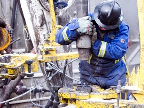 A drilling rig hand works on a Nexen Inc. well being drilled in B.C.'s Horn River shale gas play.