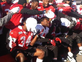 Stampeder veterans in the back give the rookies their "just reward" on Thursday at McMahon Stadium