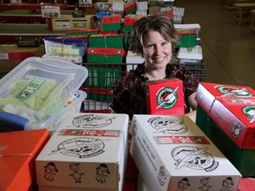 Communications advisor for Samaritan's Purse Carla Bregani, poses with some of the Operation Christmas Child shoeboxes at their warehouse in Calgary