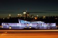 Cars streak by on the Deerfoot Trail passing Telus Spark, The New Science Centre, as the Calgary skyline looms in the background.