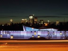 Cars streak by on the Deerfoot Trail passing Telus Spark, The New Science Centre, as the Calgary skyline looms in the background.