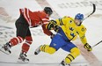 Mark Scheifele of Team Canada runs into Mika Zibanejad of Team Sweden at the 2012 IIHF World Junior Championships at Rexall Place in Edmonton.