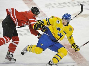 Mark Scheifele of Team Canada runs into Mika Zibanejad of Team Sweden at the 2012 IIHF World Junior Championships at Rexall Place in Edmonton.