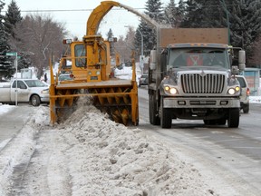 Snow clearing at work on the streets of Calgary.  Reader writes that to get it right, city council should look to Quebec or Ontario. Calgary Herald Archive