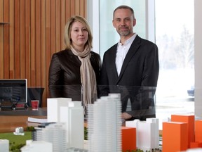 Embassy Bosa's Natalie Bosa, left, and Fred Serrafero from Fram Building Group stood with the miniature scale of the East Village development following the official opening of the presentation centre on March 23.