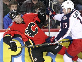 Flames' Derek Smith and the Columbus Blue Jackets' Derek Dorsett collide during the second period Sunday. Stuart Gradon, Calgary Herald