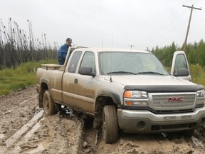A truck gets bogged down in the middle of back road south of Fort McMurray. Demand for road-building material is expected to grow as more oilsands projects are built.