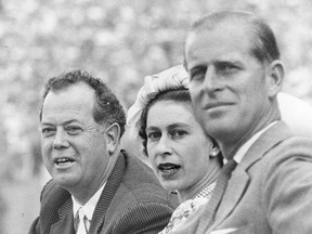 Queen Elizabeth II and Prince Philip take in a Stampede event with Mayor Don MacKay in 1959.