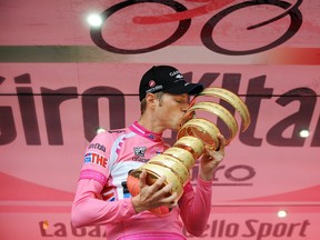 Canada's Ryder Hesjedal kisses the trophy after winning the 95th Giro d'Italia, Tour of Italy cycling race, in Milan, Italy, Sunday, Hesjedal won the 95th Giro d'Italia finishing 16 seconds ahead of Joaquin Rodriguez in the general classification after overhauling the Spaniard's lead on the final stage in Milan. Fabio Ferrari, Associated Press