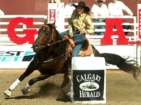 Okotoks, AB barrel racer Debbie Renger rounded the third barrel during the finals of the Calgary Stampede Barrel Racing Championship in 2004.  Herald file photo.