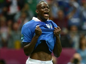 Italian forward Mario Balotelli reacts after scoring during the Euro 2012 football championships semi-final match Germany vs Italy on June 28, 2012 at the National Stadium in Warsaw.     AFP PHOTO/ PATRIK STOLLARZPATRIK STOLLARZ/AFP/GettyImages