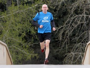 Runner Jeremy Deere crosses the Edworthy Park pedestrian bridge. Edworthy Park is home to some of the city's most beloved hikes.