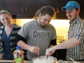 Start From Scratch students learn cooking skills from program creator Dan Clapson (right). Photo courtesy the Calgary Herald archive.